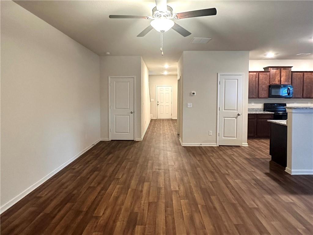 916 Independence Avenue Pendergrass, GA 30567 - Photo 5 of 30 wooden floor in an empty room with a kitchen