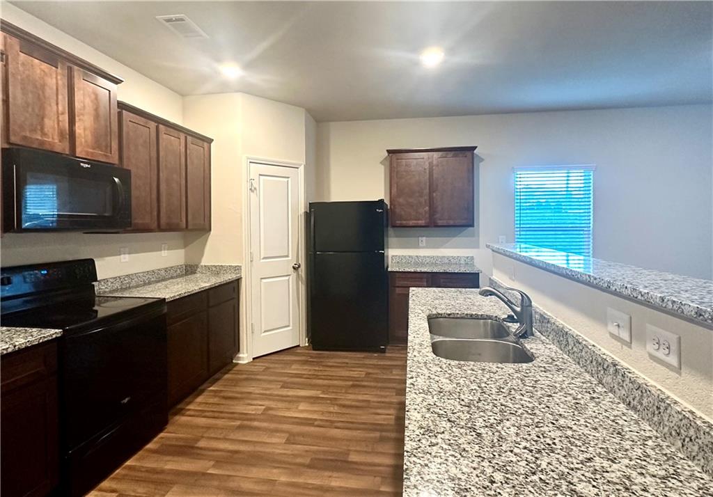 916 Independence Avenue Pendergrass, GA 30567 - Photo 7 of 30 a kitchen with a refrigerator stove and sink