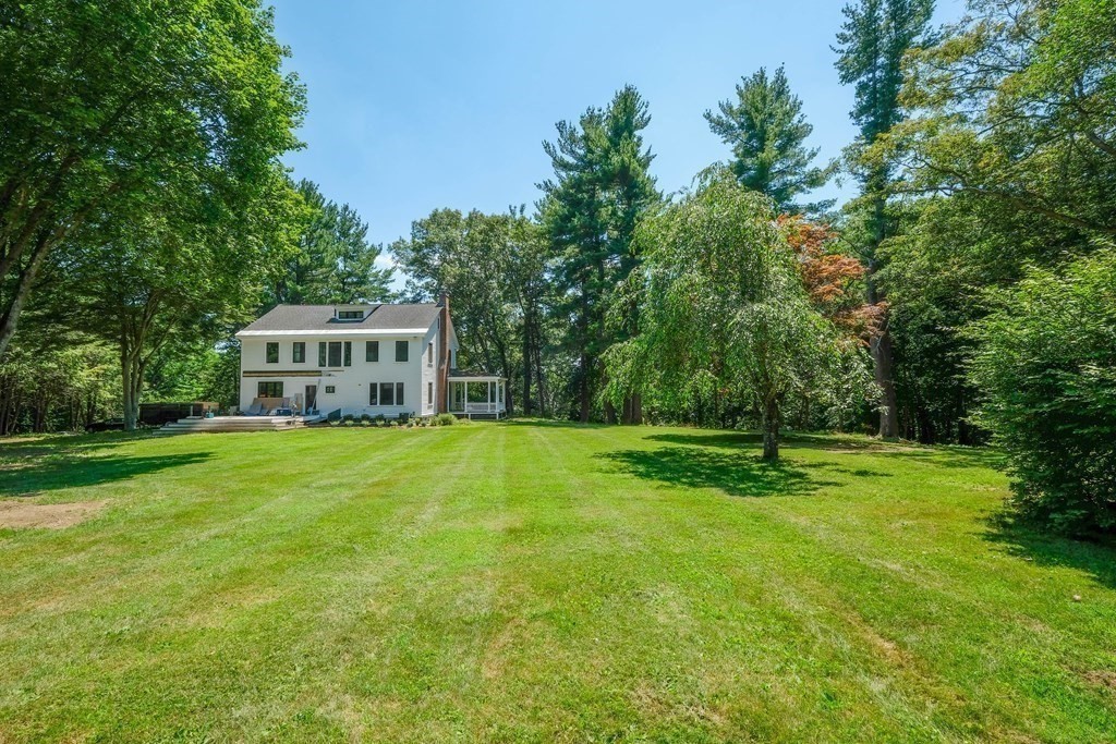 270 Concord Road Wayland, MA 01778 - Photo 7 of 9 a view of a house with a big yard and large trees