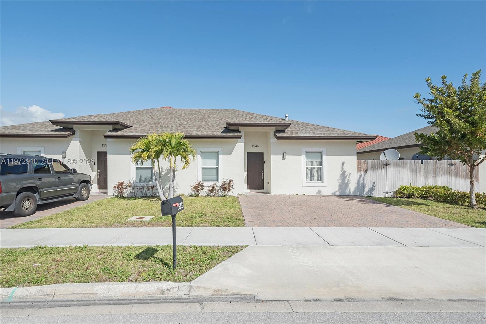 1546 West 26th Court Riviera Beach, FL 33404 - Photo 2 of 13 a front view of a house with a yard