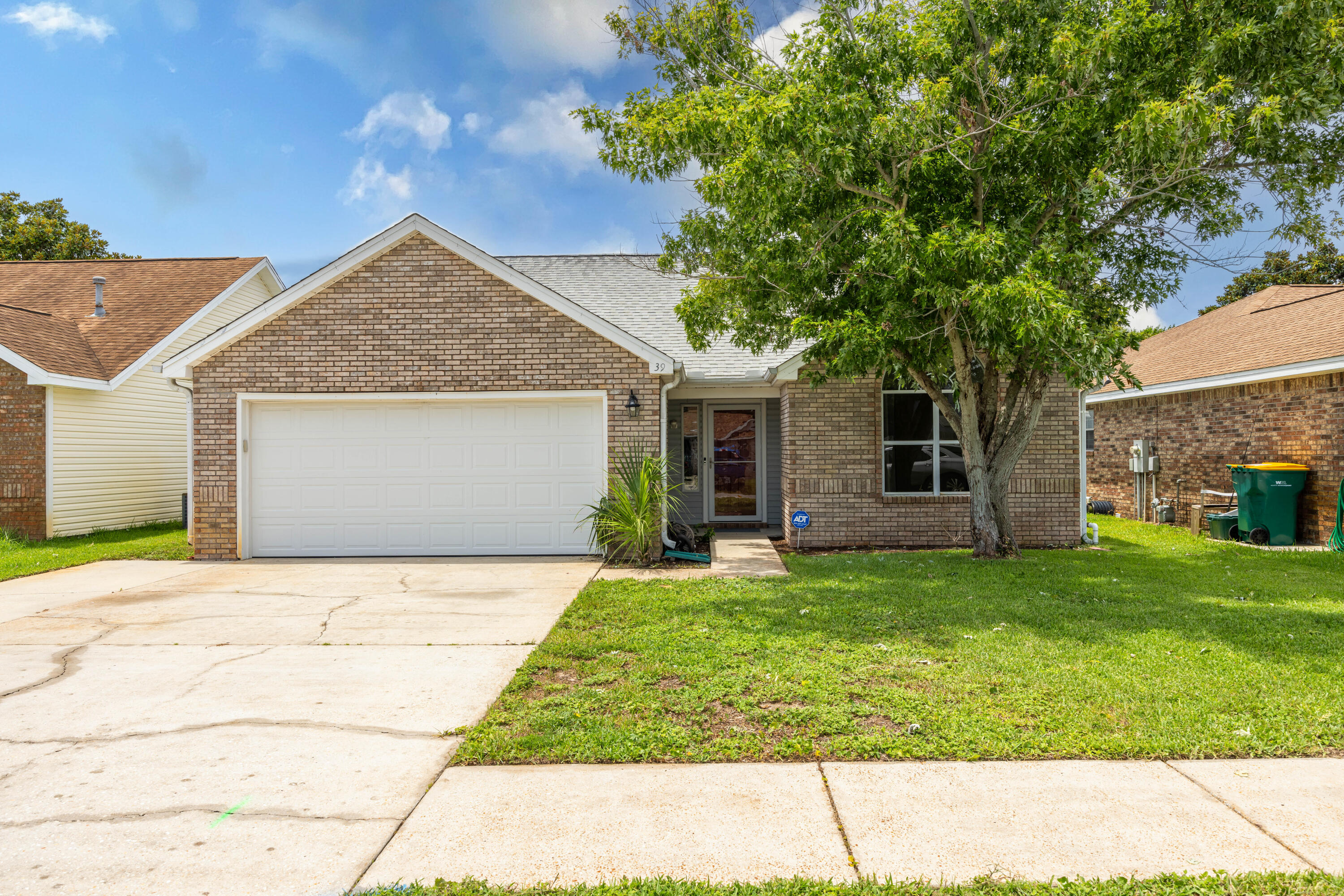 39 Pine Ridge Trace Destin, FL 32541 - Photo 2 of 42 a front view of a house with a garden and yard