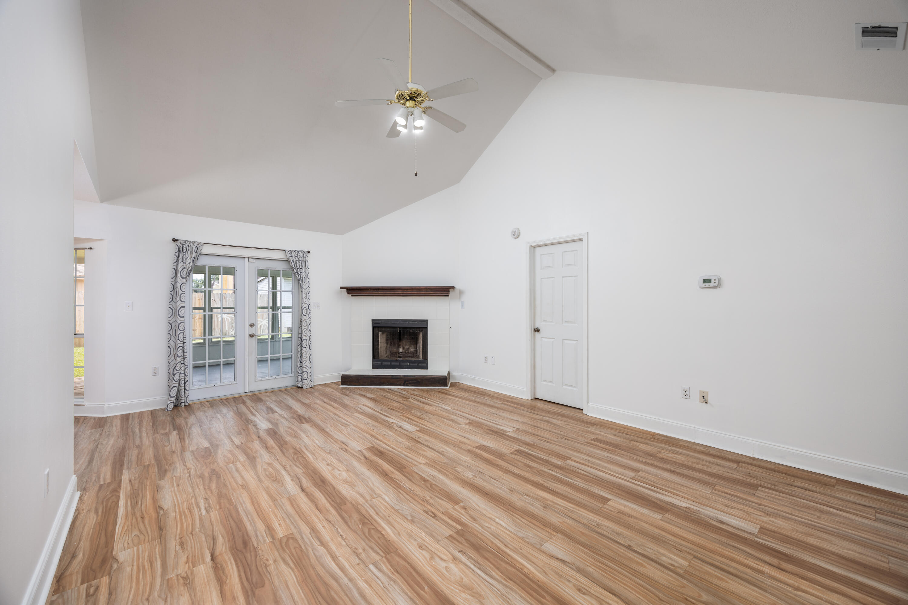 39 Pine Ridge Trace Destin, FL 32541 - Photo 24 of 42 a view of empty room with wooden floor and fireplace