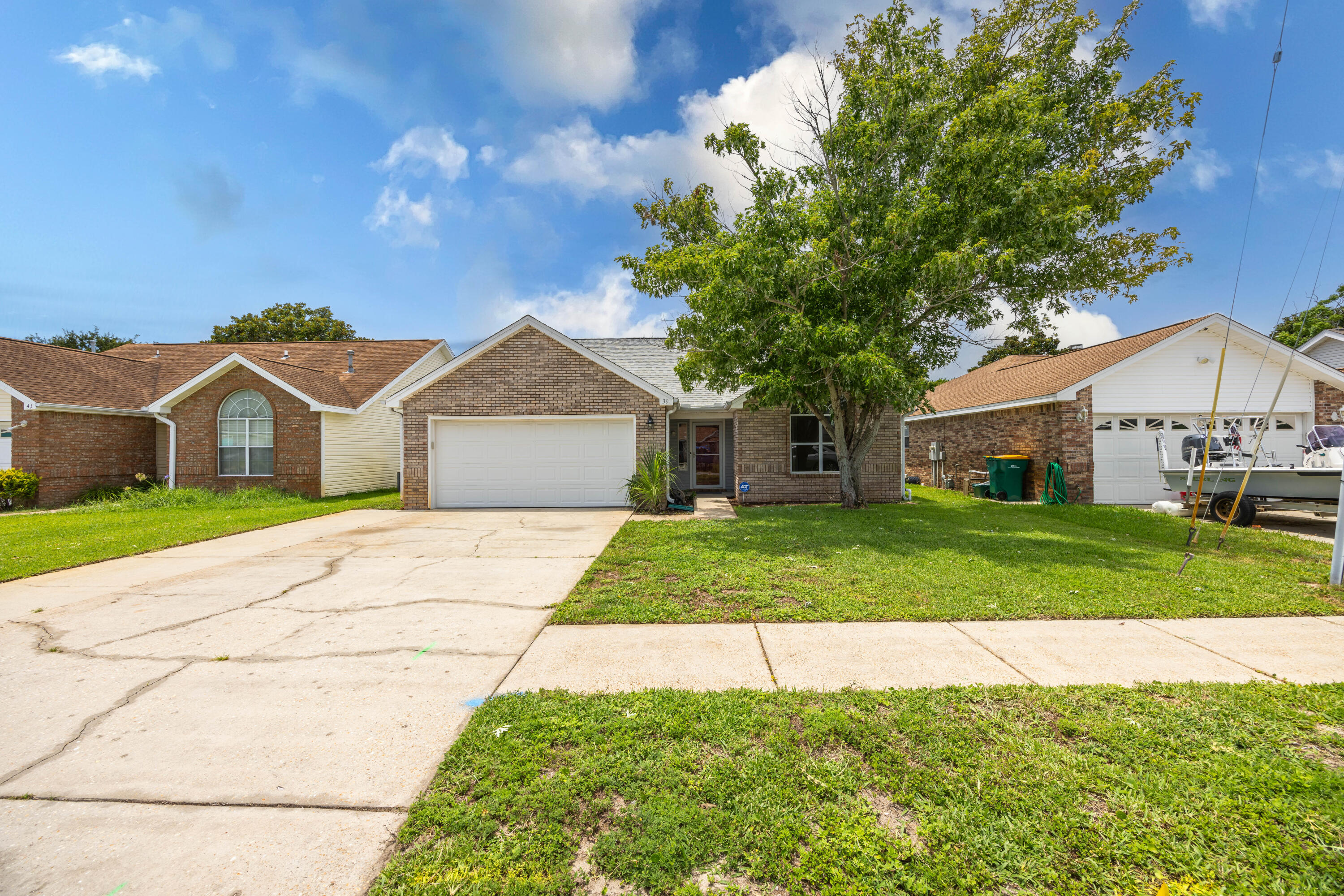 39 Pine Ridge Trace Destin, FL 32541 - Photo 37 of 42 a front view of a house with a yard and garage