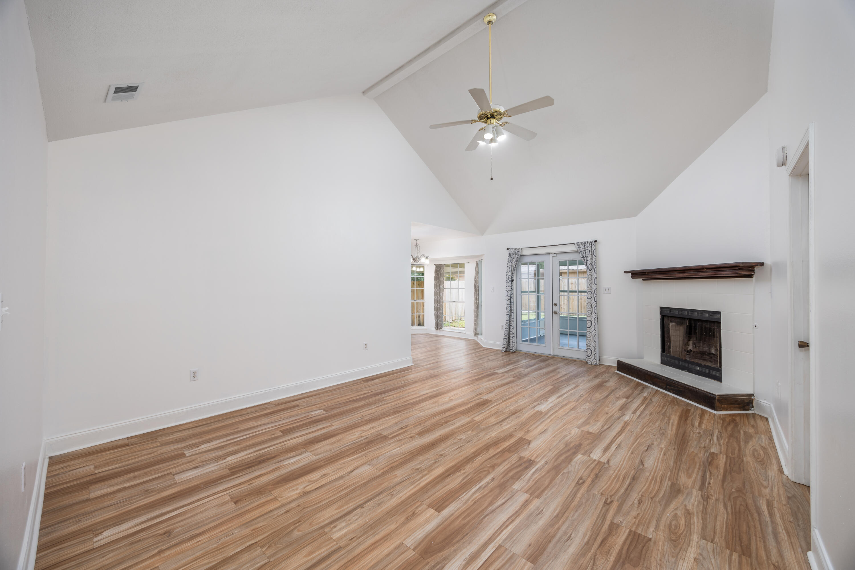 39 Pine Ridge Trace Destin, FL 32541 - Photo 5 of 42 wooden floor in an empty room with a fireplace