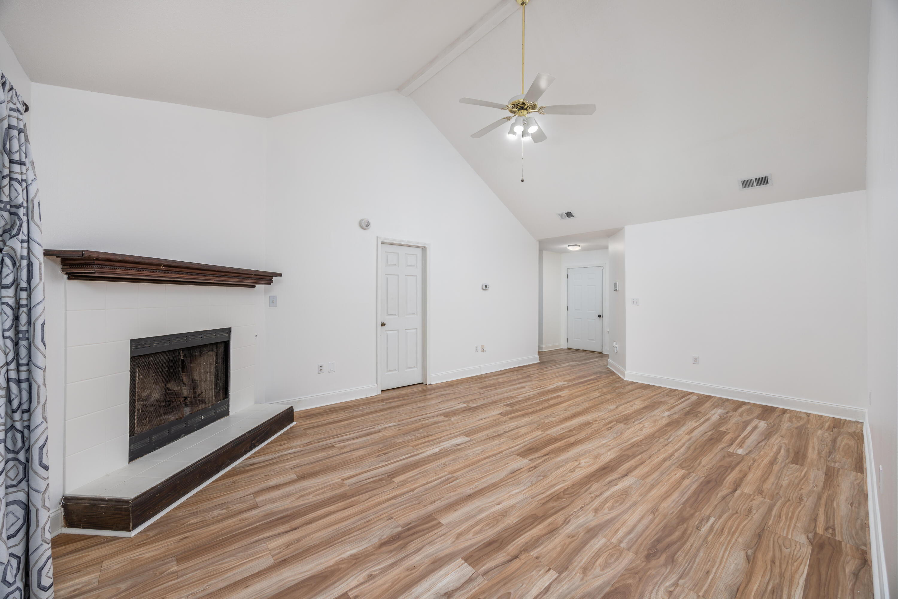 39 Pine Ridge Trace Destin, FL 32541 - Photo 6 of 42 a view of empty room with wooden floor and fireplace