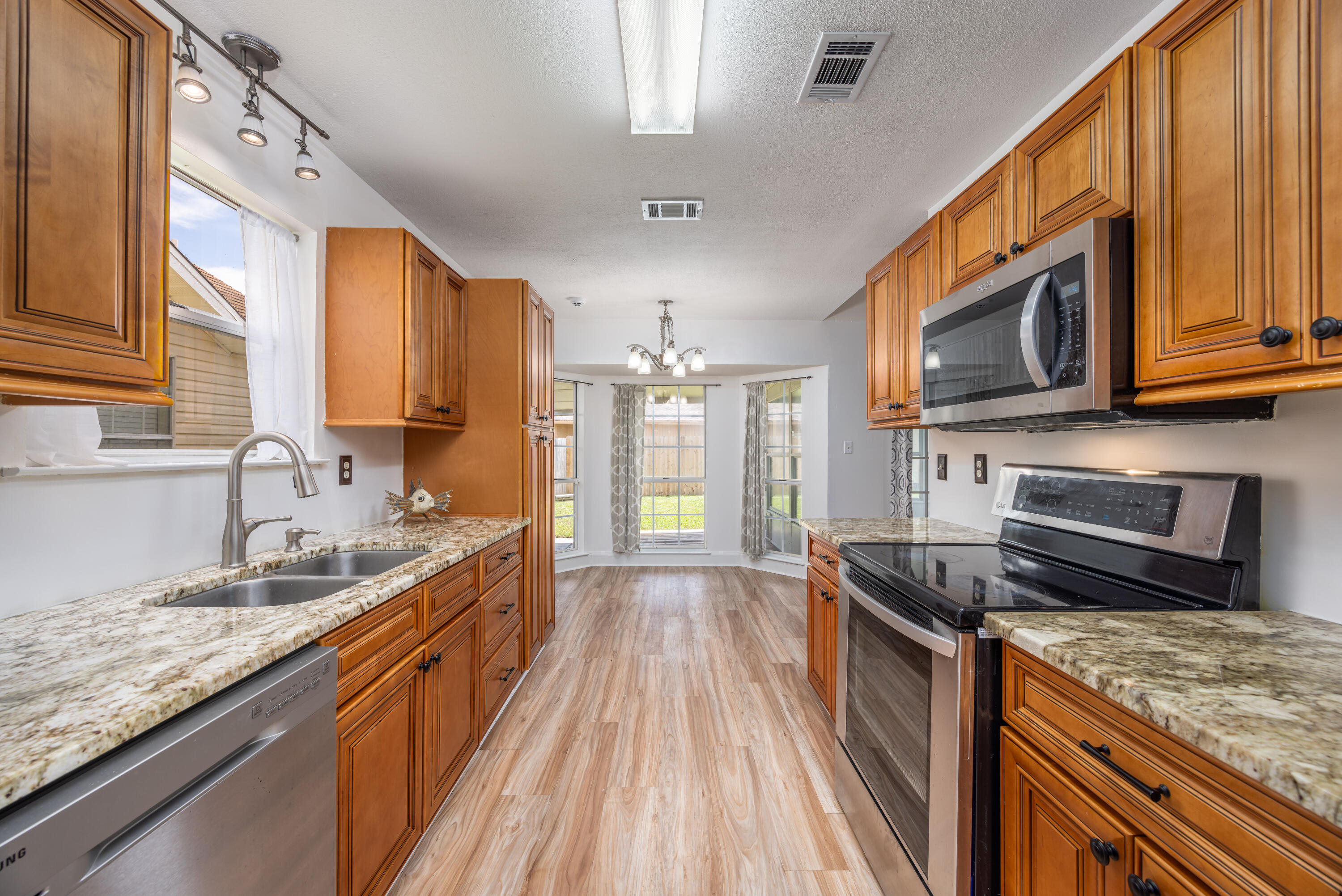 39 Pine Ridge Trace Destin, FL 32541 - Photo 10 of 42 a kitchen with stainless steel appliances granite countertop a sink stove and cabinets