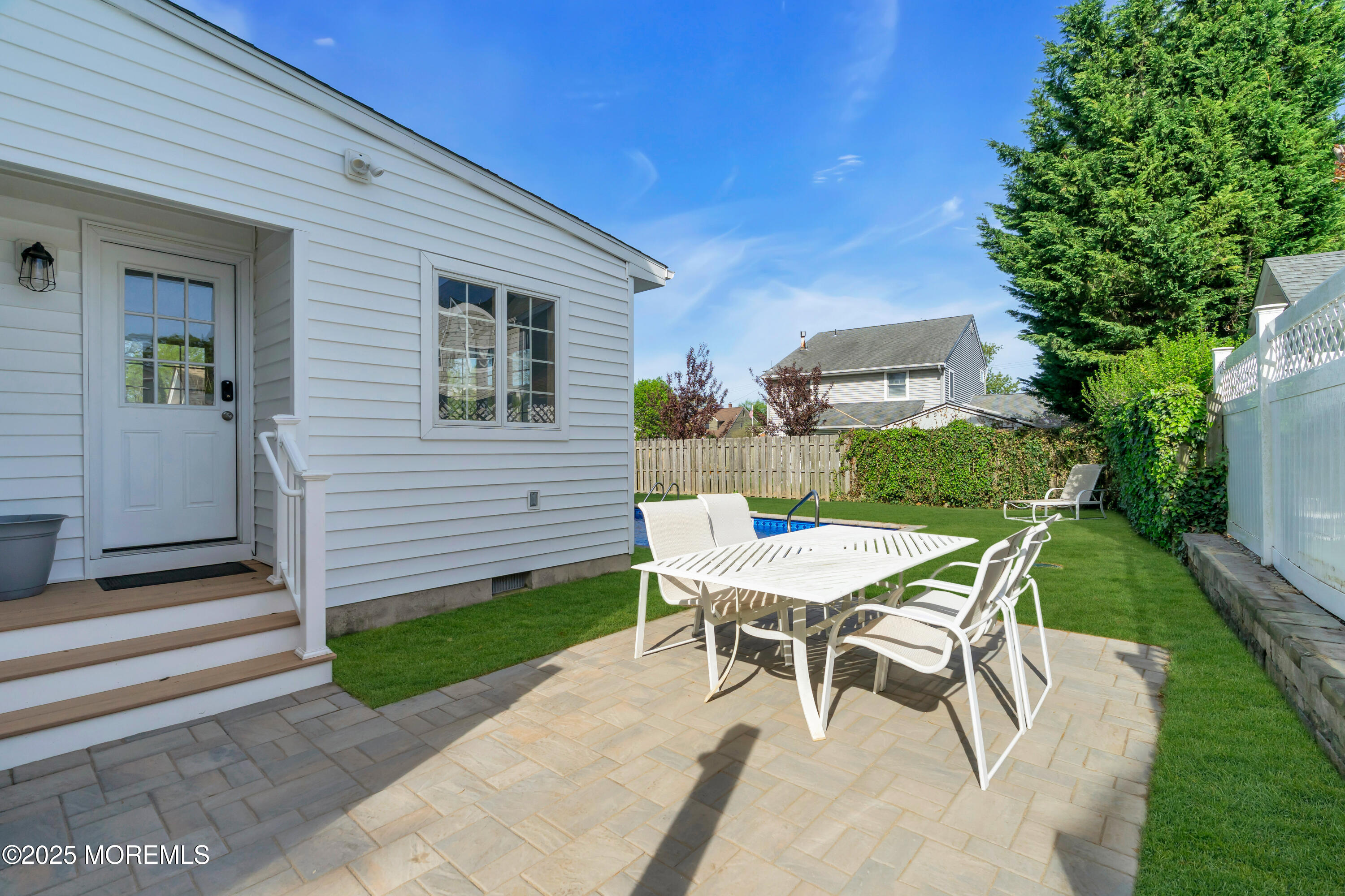 a view of a patio with table and chairs and potted plants