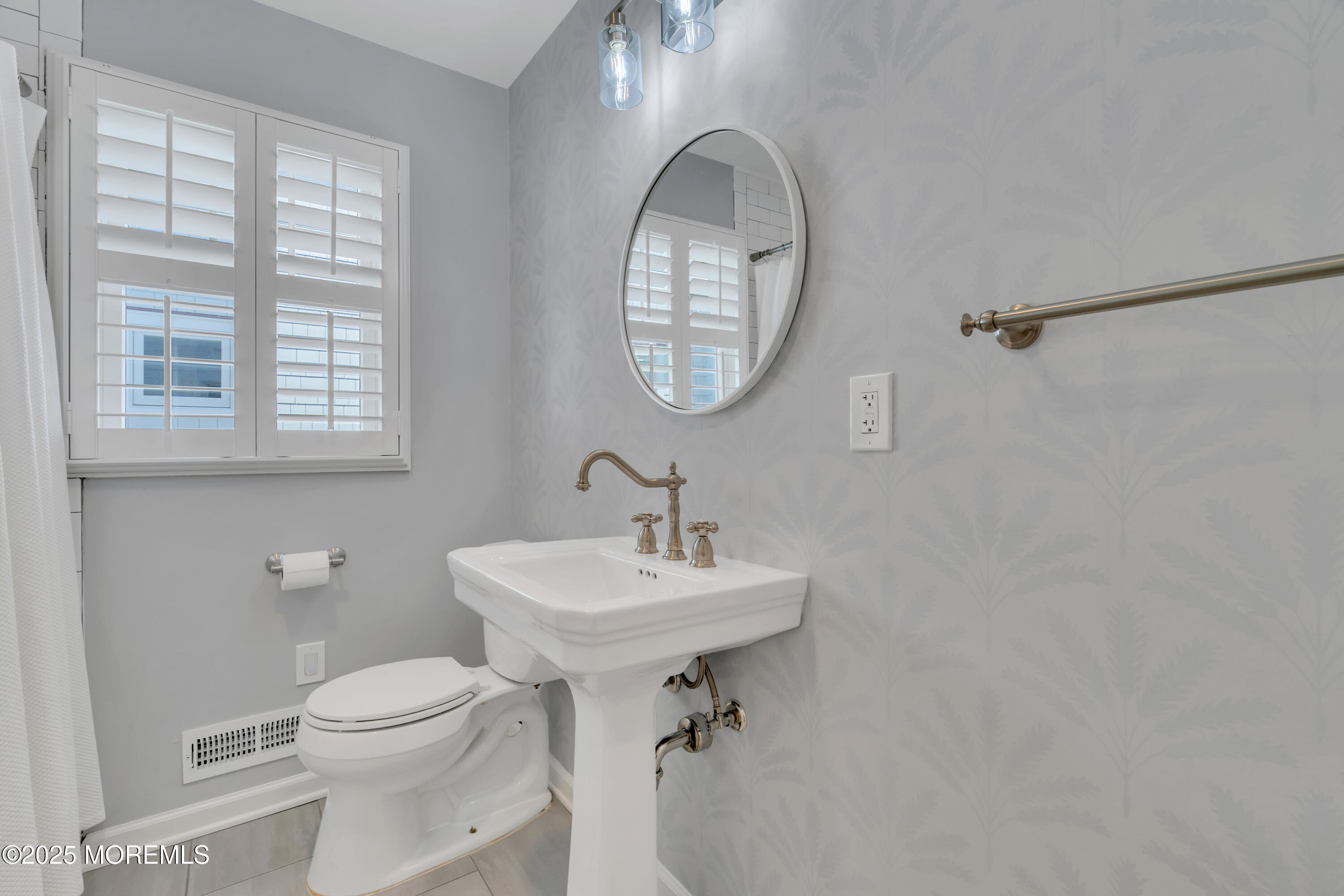 312 Woodland Road Point Pleasant Beach, NJ 08742 - Photo 21 of 52 a bathroom with a sink a mirror and a toilet