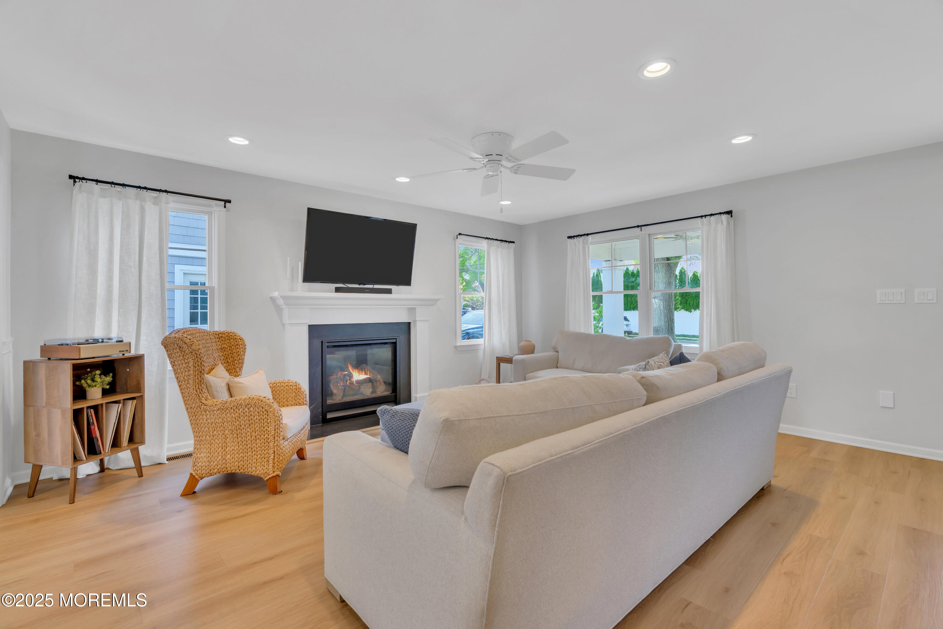 312 Woodland Road Point Pleasant Beach, NJ 08742 - Photo 23 of 52 a living room with furniture a flat screen tv and a fireplace
