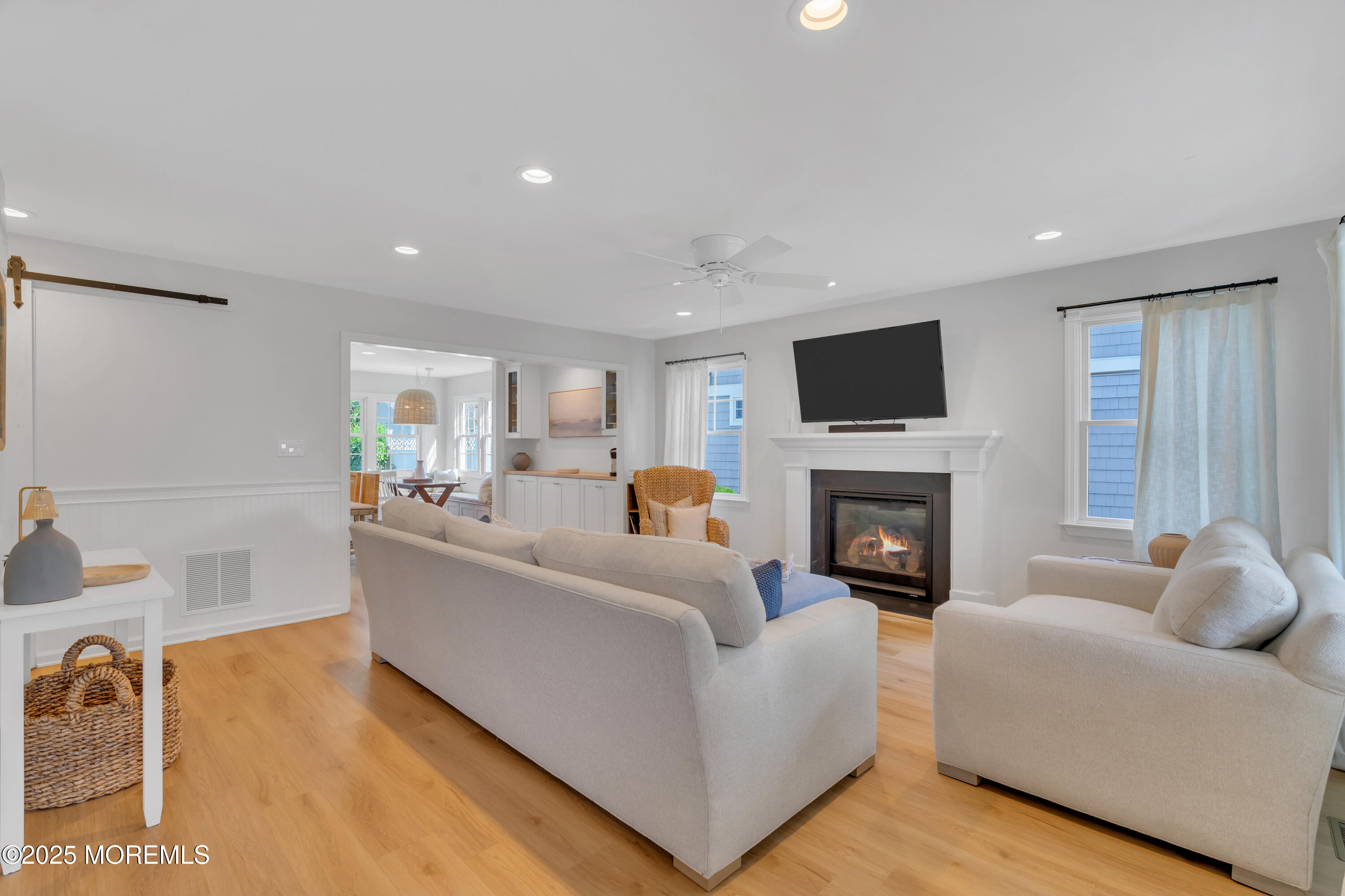 312 Woodland Road Point Pleasant Beach, NJ 08742 - Photo 33 of 52 a living room with furniture a fireplace and a flat screen tv