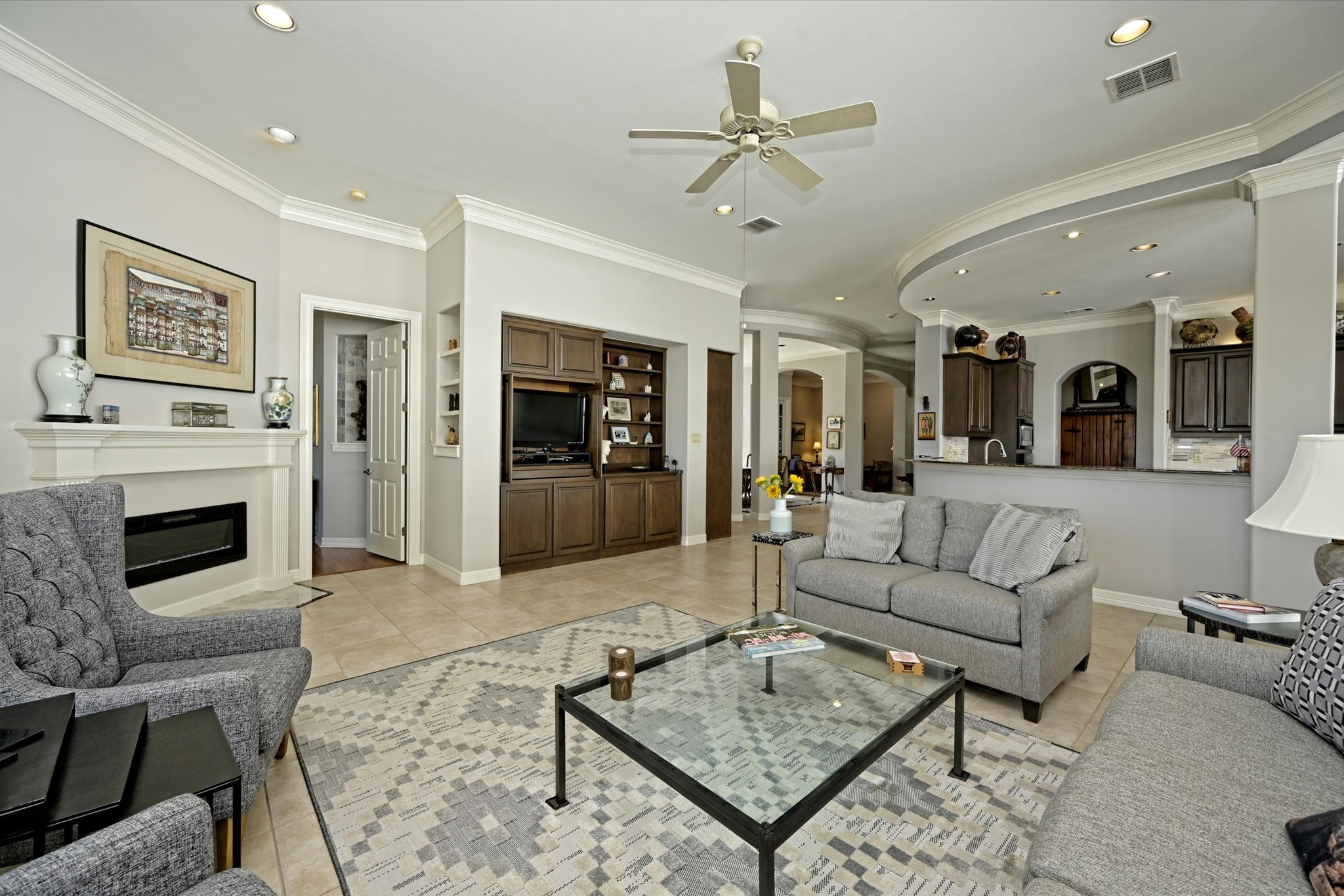 4912 Interlachen Lane Austin, TX 78747 - Photo 2 of 39 a living room with furniture a fireplace and a table