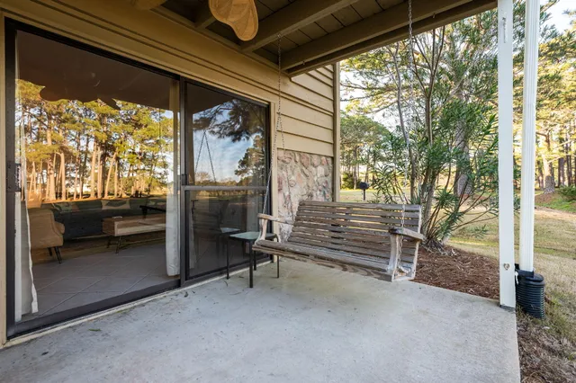 a view of patio with table and chairs and potted plants