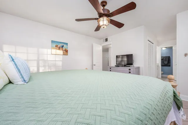 a bathroom with a granite countertop sink a toilet and a mirror