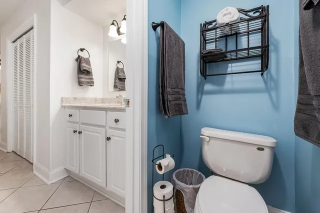a view of a tennis ground with large trees