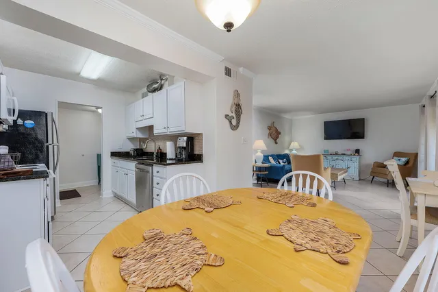 a large bedroom with a bed and a flat screen tv