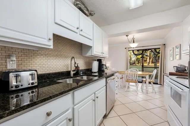 a kitchen with stainless steel appliances a sink stove and cabinets
