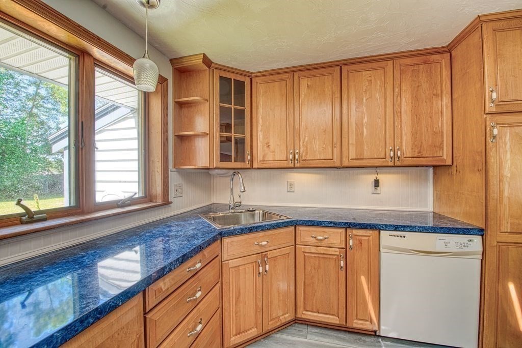 81 Errol Road Brockton, MA 02302 - Photo 20 of 31 a kitchen with stainless steel appliances granite countertop a sink and cabinets with wooden floor