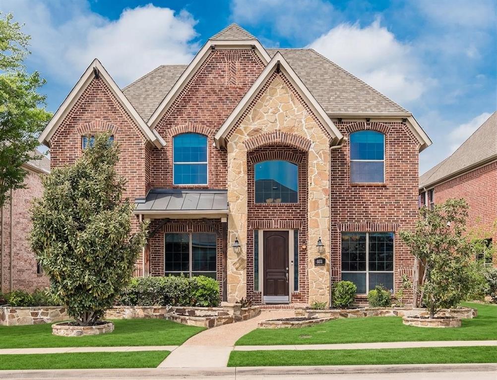 8631 Lohr Valley Road Irving, TX 75063 - Photo 1 of 32 View of front of home featuring brick siding, a front yard, a standing seam roof, and stone siding