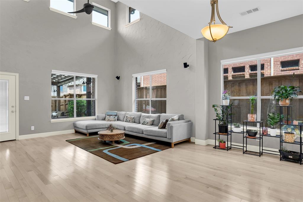 8631 Lohr Valley Road Irving, TX 75063 - Photo 9 of 32 Living room featuring light wood finished floors and a high ceiling