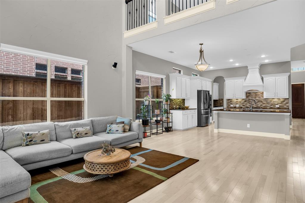 8631 Lohr Valley Road Irving, TX 75063 - Photo 11 of 32 Living room featuring light wood-style floors, arched walkways, a high ceiling, and recessed lighting