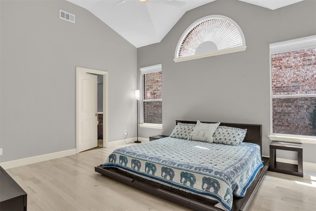 8631 Lohr Valley Road Irving, TX 75063 - Photo 13 of 32 Bedroom with light wood-type flooring, lofted ceiling, and a ceiling fan