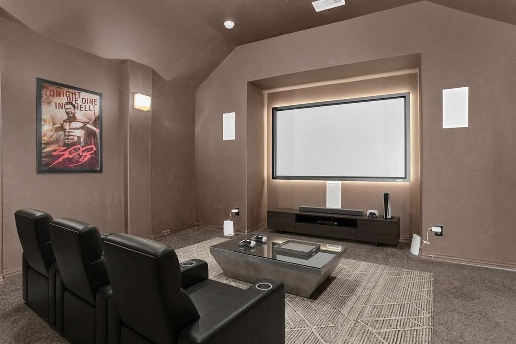 8631 Lohr Valley Road Irving, TX 75063 - Photo 19 of 32 Home theater room with dark carpet and vaulted ceiling