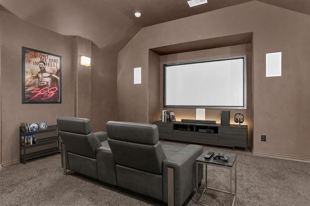 8631 Lohr Valley Road Irving, TX 75063 - Photo 20 of 32 Carpeted cinema with lofted ceiling and baseboards