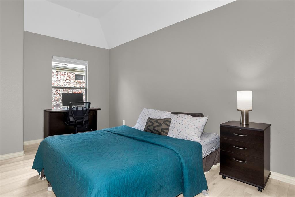 8631 Lohr Valley Road Irving, TX 75063 - Photo 25 of 32 Bedroom featuring a desk, light wood-style floors, and lofted ceiling