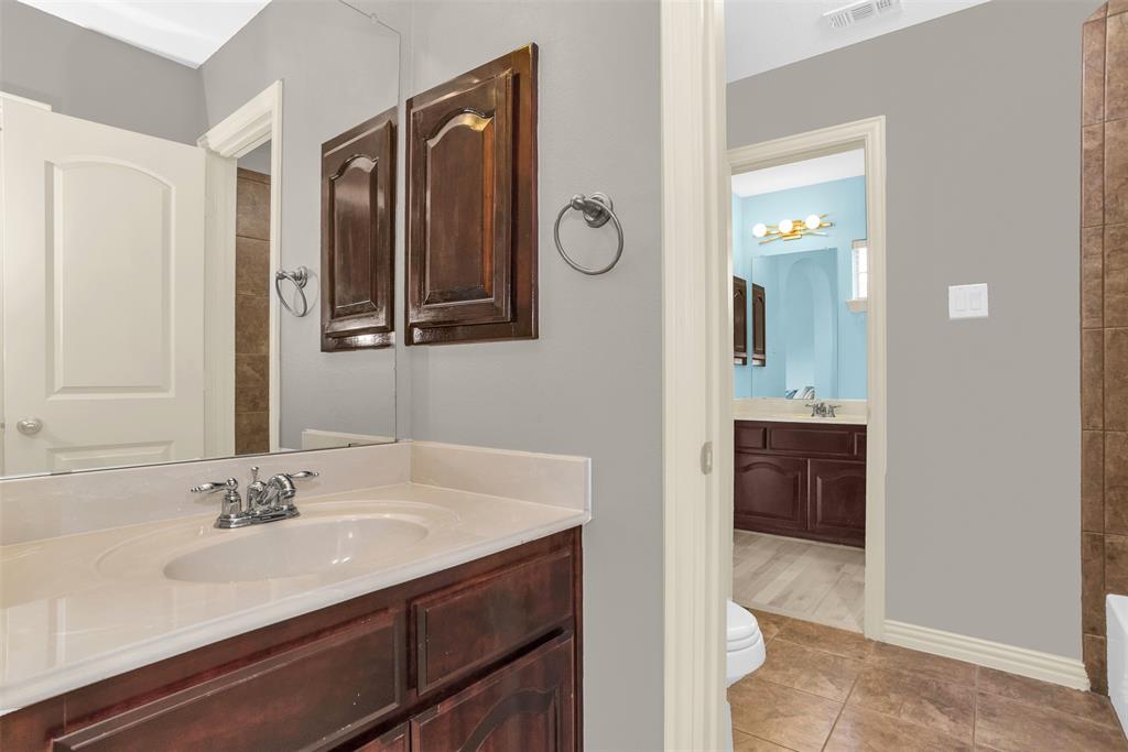 8631 Lohr Valley Road Irving, TX 75063 - Photo 26 of 32 Full bath with vanity and light tile patterned floors