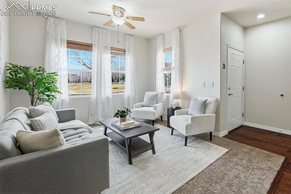 a living room with furniture and wooden floor