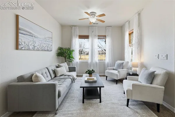 a living room with furniture and a large window