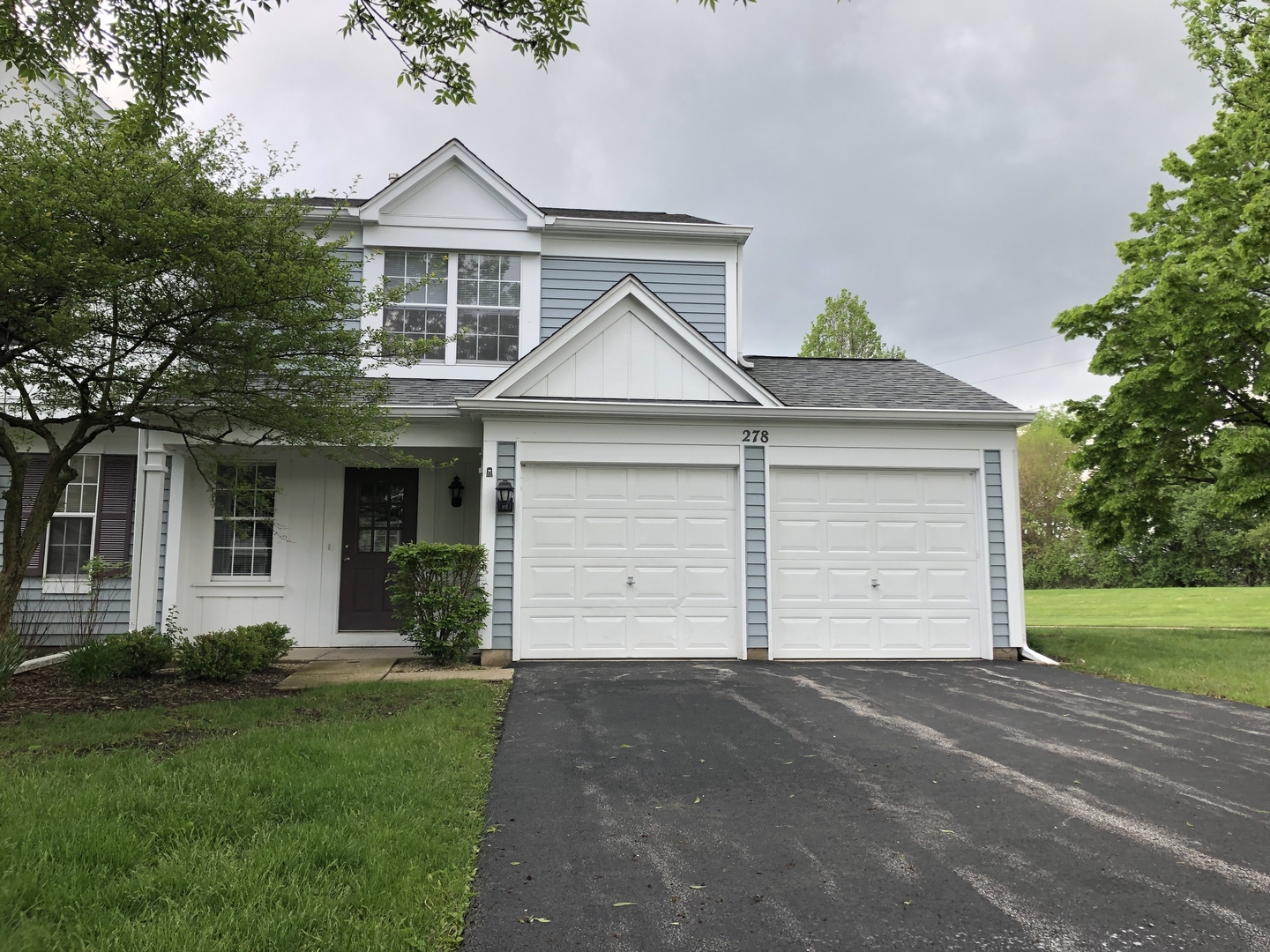 278 Half Moon Circle Aurora, IL 60504 - Photo 1 of 19 a front view of a house with a yard and garage