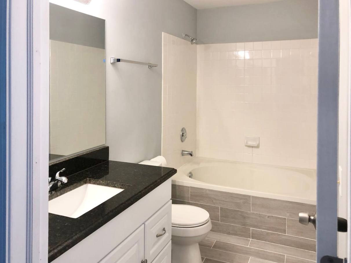 278 Half Moon Circle Aurora, IL 60504 - Photo 15 of 19 a bathroom with a granite countertop bathtub shower sink vanity and toilet