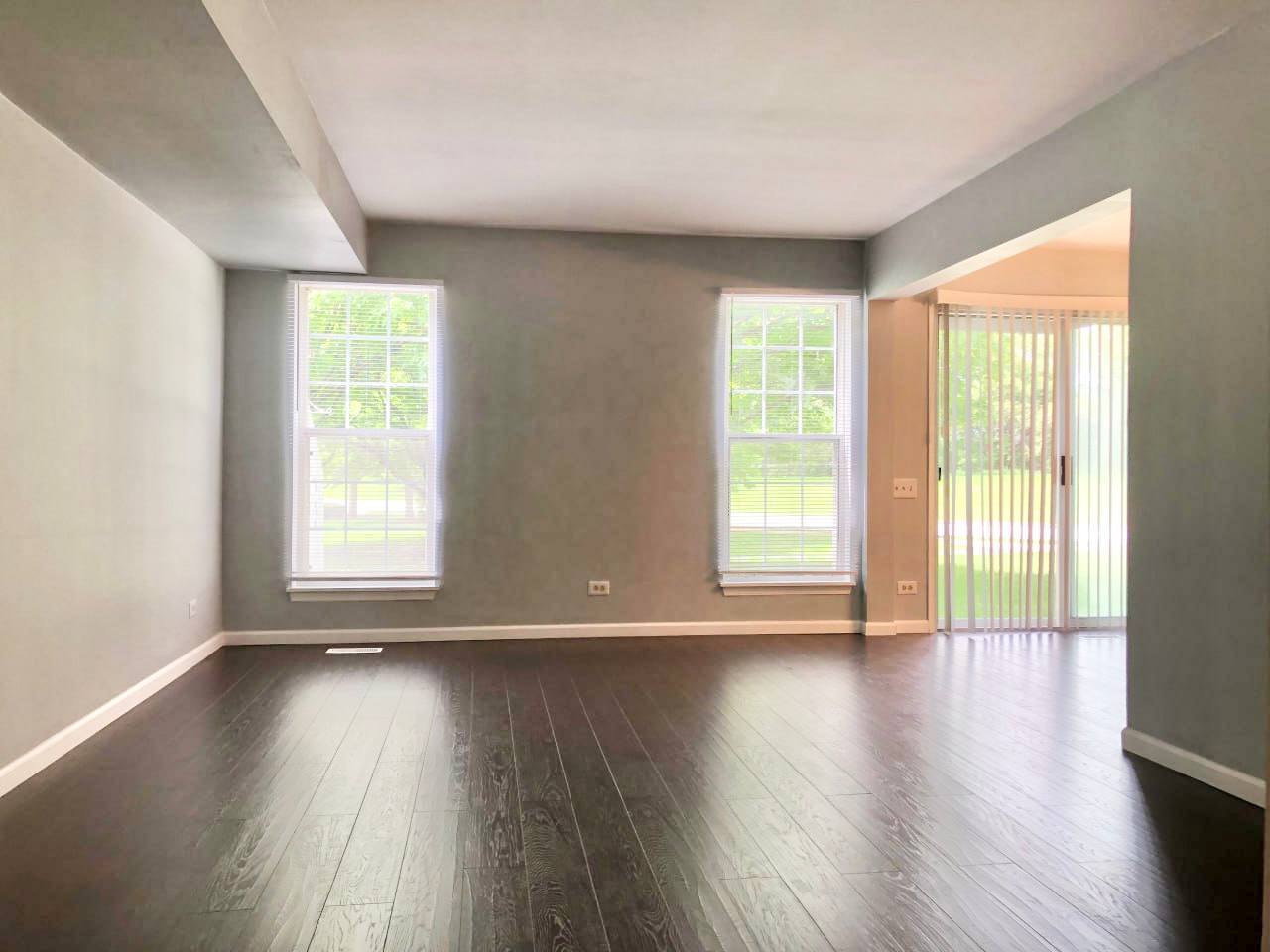 278 Half Moon Circle Aurora, IL 60504 - Photo 4 of 19 a view of an empty room with wooden floor and a window