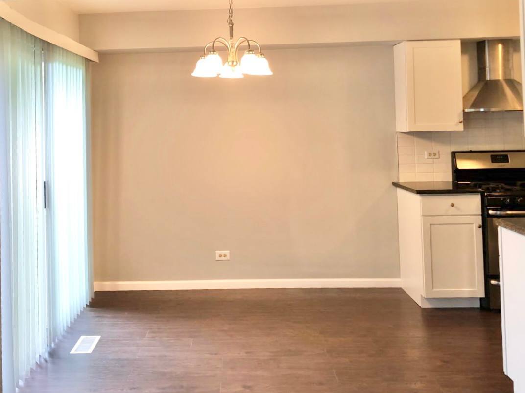 278 Half Moon Circle Aurora, IL 60504 - Photo 6 of 19 a view of kitchen with granite countertop cabinets and outdoor view