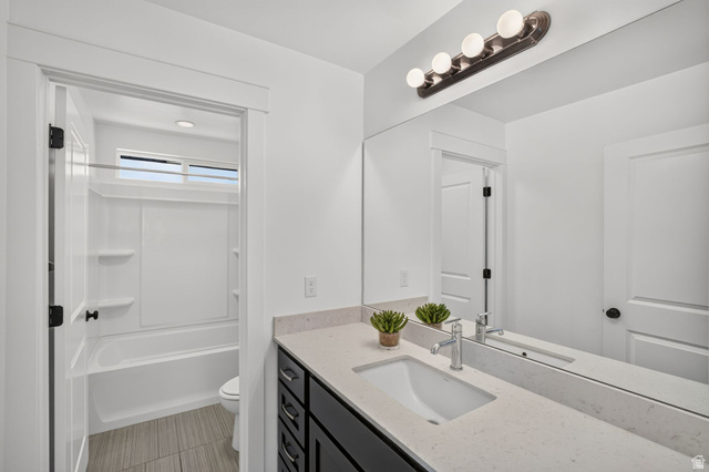 6536 West Muirfield Road Highland, UT 84003 - Photo 20 of 48 Bathroom featuring a dark wood-finish vanity with a light countertop and integrated sink