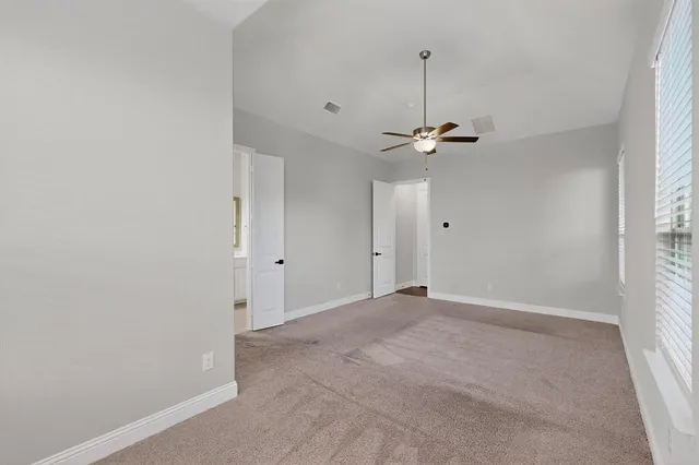 a view of a room with a ceiling fan