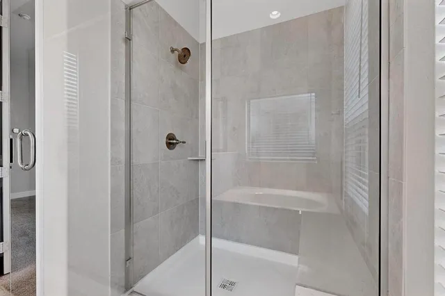 a bathroom with a glass shower door