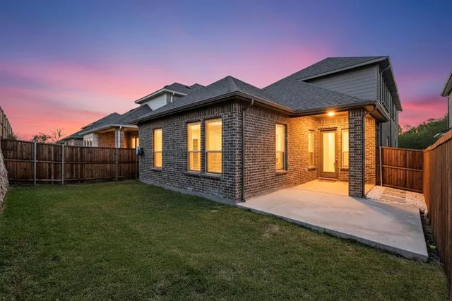 a view of backyard of house with wooden floor and fence