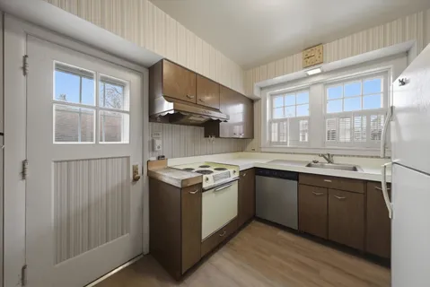 a kitchen with stainless steel appliances granite countertop a stove and a sink