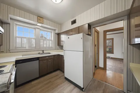 a kitchen with refrigerator a sink and cabinets