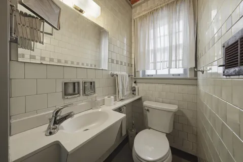 a bathroom with a sink a toilet and tub