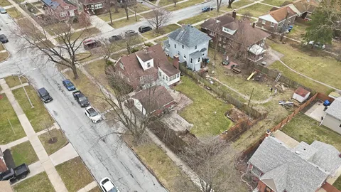an aerial view of residential houses with outdoor space