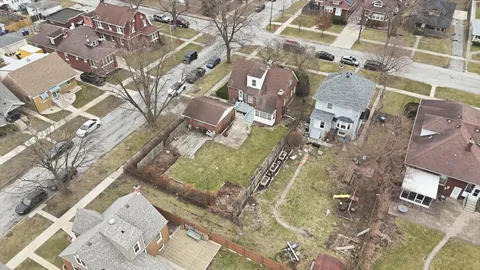 an aerial view of residential houses with outdoor space and parking