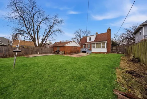 a view of garage yard and deck