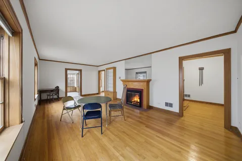 a living room with furniture a fireplace and a floor to ceiling window