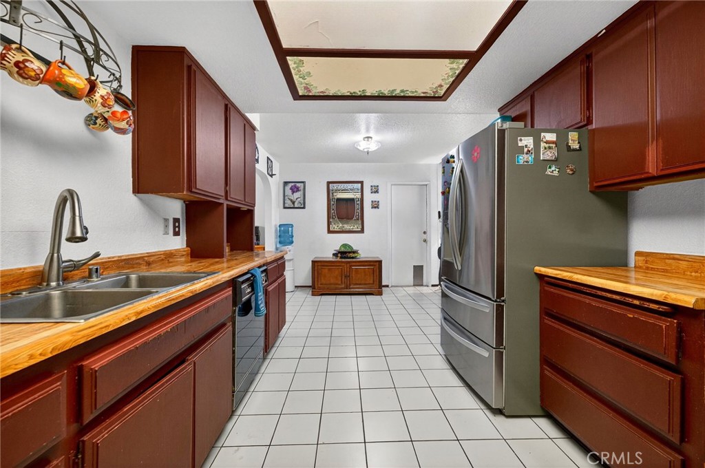 4153 North Webster Avenue Perris, CA 92571 - Photo 11 of 49 a kitchen with stainless steel appliances granite countertop a refrigerator a sink and dishwasher