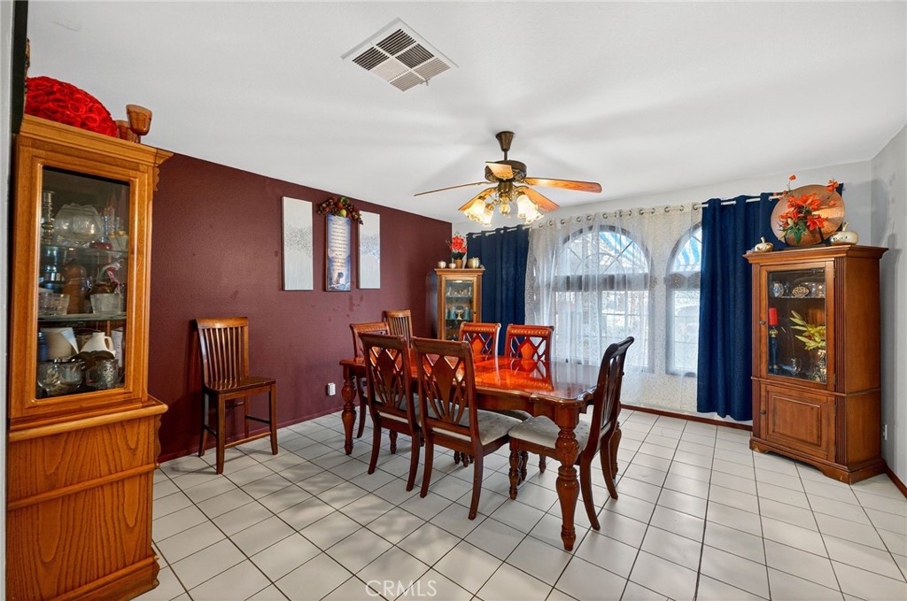 4153 North Webster Avenue Perris, CA 92571 - Photo 13 of 49 a view of a dining room with furniture and chandelier