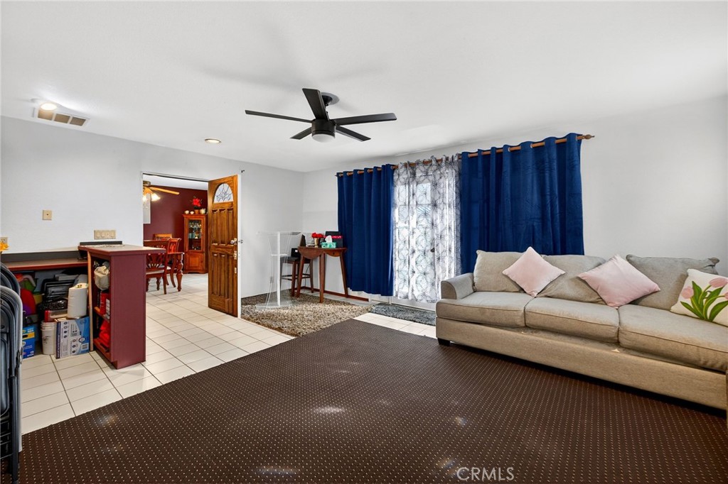 4153 North Webster Avenue Perris, CA 92571 - Photo 17 of 49 a living room with furniture and a dining table
