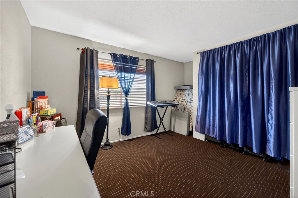 4153 North Webster Avenue Perris, CA 92571 - Photo 21 of 49 a view of a room with furniture and a window